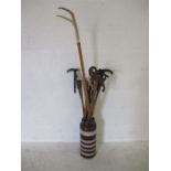 A collection of walking sticks in a West German vase/stick stand