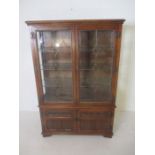 An oak Old Charm display cabinet with cupboard under, leaded light detailing.