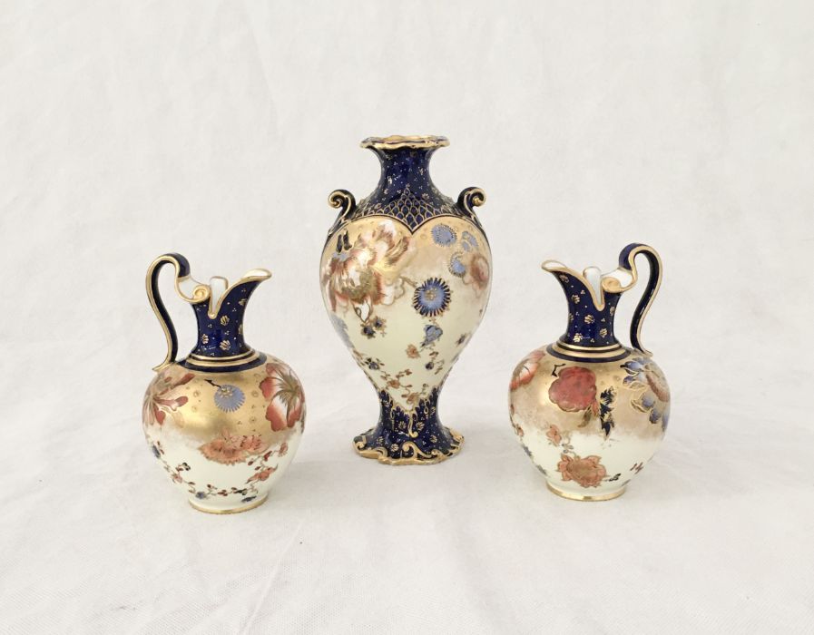A pair of Royal Crown Derby jugs and vase in the Imari pattern