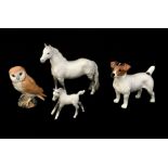 A collection of Beswick animals including an owl, Jack Russell, dapple grey foal and dapple grey