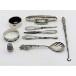 A collection of hallmarked silver items including nail buffer, serviette ring, continental spoon