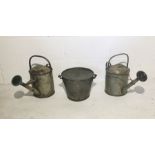 Two galvanised watering cans and a galvanised lidded bucket