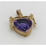 An unmarked gold articulated heart shaped pendant set with amethyst and seed pearls