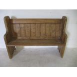 A vintage pine pew, width 124cm