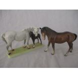 A Beswick Mare and Foal on base: Beswick grey mare with bay foal on ceramic grass base model 1811 (