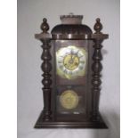 An early 20th Century bracket clock with Roman numerals on a silvered and brass dial