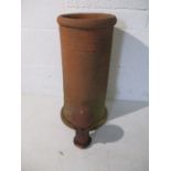 A terracotta chimney pot along with a finial