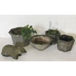 A small collection of concrete planters and concrete badger garden ornament