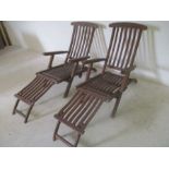 Two steamer style teak garden chairs.