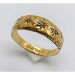 An 18ct gold ring set with three small diamonds