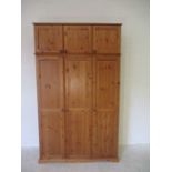 A large pine triple wardrobe with additional top box storage. 121cm x 30cm, height 223cm.