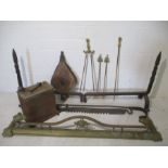 A fireside set including a brass fender, fire dogs, a poker and tong set , a chimney crook plus a