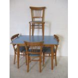 A mid century Formica topped table and four chairs