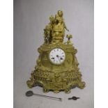 An ornate French clock decorated in ormolu