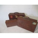 Two vintage suitcases with labels, along with one other.