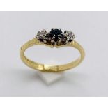 A diamond and sapphire three stone ring set in 18ct gold