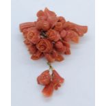 A Victorian coral brooch with gold coloured mount ( tested as 15ct) carved with roses and foliage,