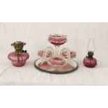 A large cranberry glass centrepiece - A/F - along with two smaller oil lamps