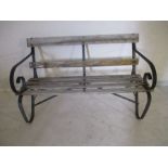 A vintage garden bench with wrought iron supports