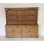 A large pine dresser with four drawers and two cupboards under H194cm W194cm D40cm