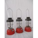 Three red vintage Tilley lamps