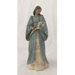 A Lladro porcelain figure of a woman holding a bunch of lilies, "Serenity", 17" high.