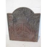 A 17th Century style cast iron fire back made by Kingsworthy foundry depicting an inverted anchor