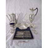 A collection of silver plated items including a hot water jug, sugar bowl with blue glass liner