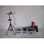 An assortment of bicycle related goods including helmet, bike stand, bike cover, lights, handle