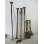 Four acro props along with a quantity of shovels