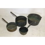 A collection of large heavy copper pans and jam pan.