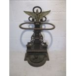 An ornate cast iron umbrella stand