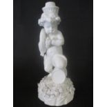 A Meissen figure of a Putti playing a sousaphone like horn ( horn missing) kneeling on a drum,