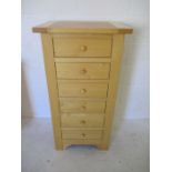 A modern beech upright chest of six drawers