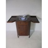 A Georgian mahogany inlaid washstand with double opening lift lid revealing wells for wash basin set