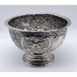 A hallmarked silver bowl with repousse decoration, London 1902 made by the Goldsmiths & Silversmiths
