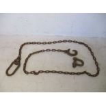 A vintage cast iron link chain with hook to one end