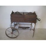 A vintage cast iron hot chestnut cart