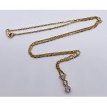 An 18ct gold and diamond pendant set with 3 graduated diamonds with integral chain