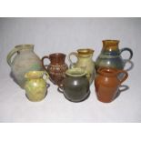 A collection of seven studio pottery jugs
