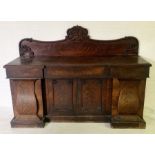A large Victorian mahogany sideboard with with three drawers above four doors enclosing sliding