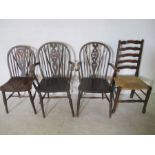 An antique Windsor chair along with two similar carvers and a rush seated ladder back chair