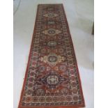 A Kadjar red ground runner - length 340cm, width 91cm