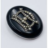 A Victorian silver mounted mourning brooch set with seed pearls A/F