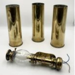 Three WW2 shells along with a White Star lamp