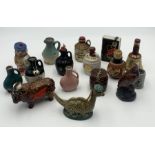 A collection of novelty miniature whisky bottles including Beswick Beneagles and Loch Ness Monster