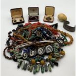 A collection of costume jewellery including a Malachite necklace and an amber coloured necklace