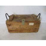 A wooden ammo box with rope handles