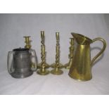 A collection of brassware including two sets of barley twist candlesticks, plus a three handled