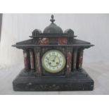 A large Victorian slate mantle clock. Clock face is marked "Exam'd by Wales & McCulloch, London"
